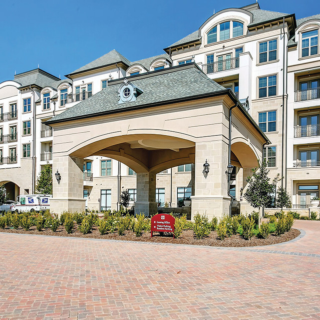 Exterior building view at The Huntington Apartments in Plano, TX