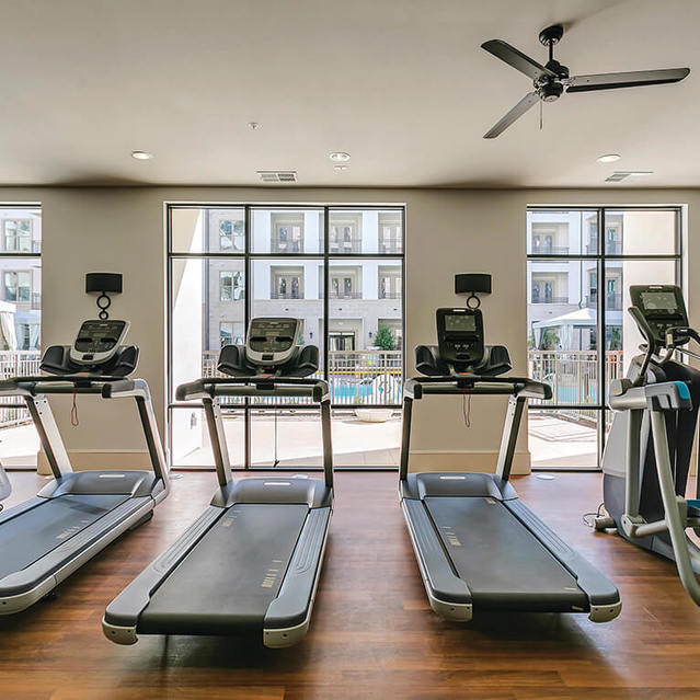 Fitness center cardio machines at The Huntington Apartments in Plano, TX