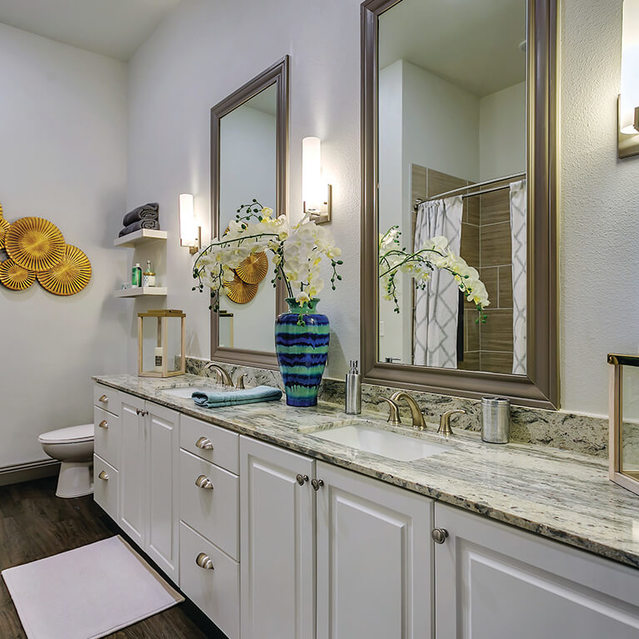 Model bathroom with double vanity at The Huntington Apartments in Plano, TX